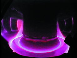 View into the plasma of Asdex Upgrade. The edge of the plasma is directed onto the robust divertor plates at the bottom of the vessel.